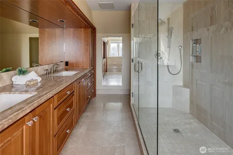 a bathroom with a granite countertop sink and a bathtub