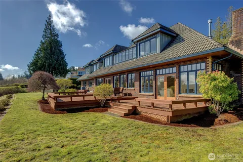 a view of a house with swimming pool and sitting area