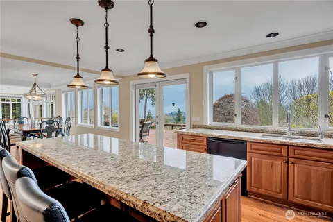 a dining room with furniture a chandelier and wooden floor
