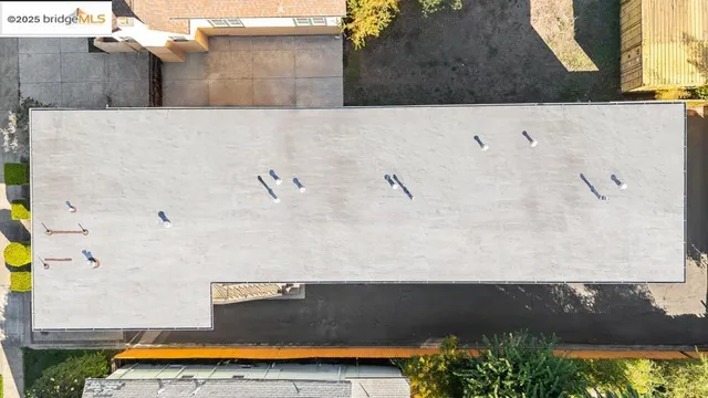 an aerial view of a house with a yard