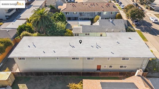 an aerial view of a house with a yard and wooden fence