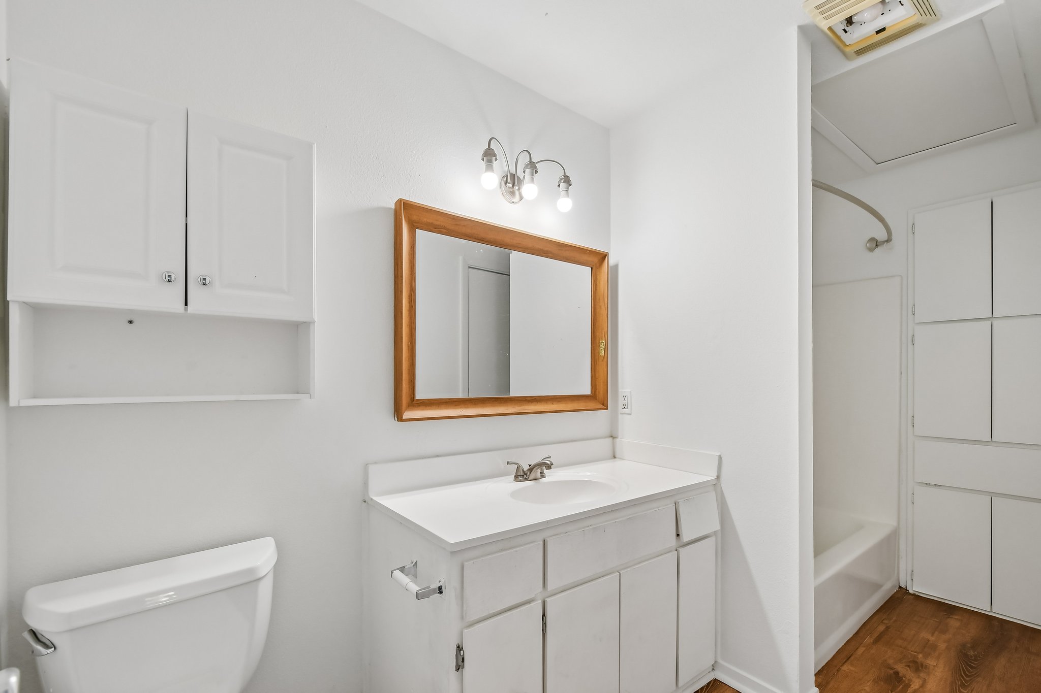 4202 Hudson Bend Road, Unit B Austin, TX 78734 - Photo 15 of 26 a bathroom with a toilet a sink a mirror and vanity