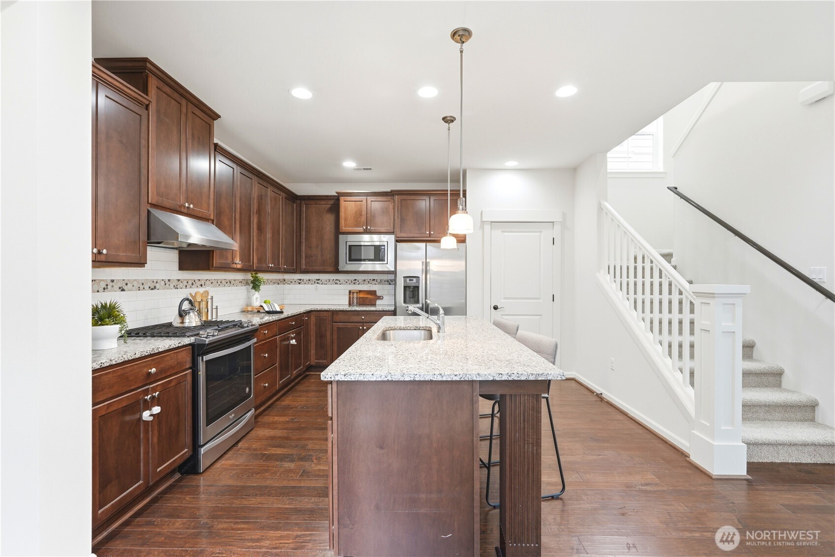 4413 185th Place Southeast Bothell, WA 98012 - Photo 13 of 40 a large kitchen with kitchen island a sink stainless steel appliances and cabinets