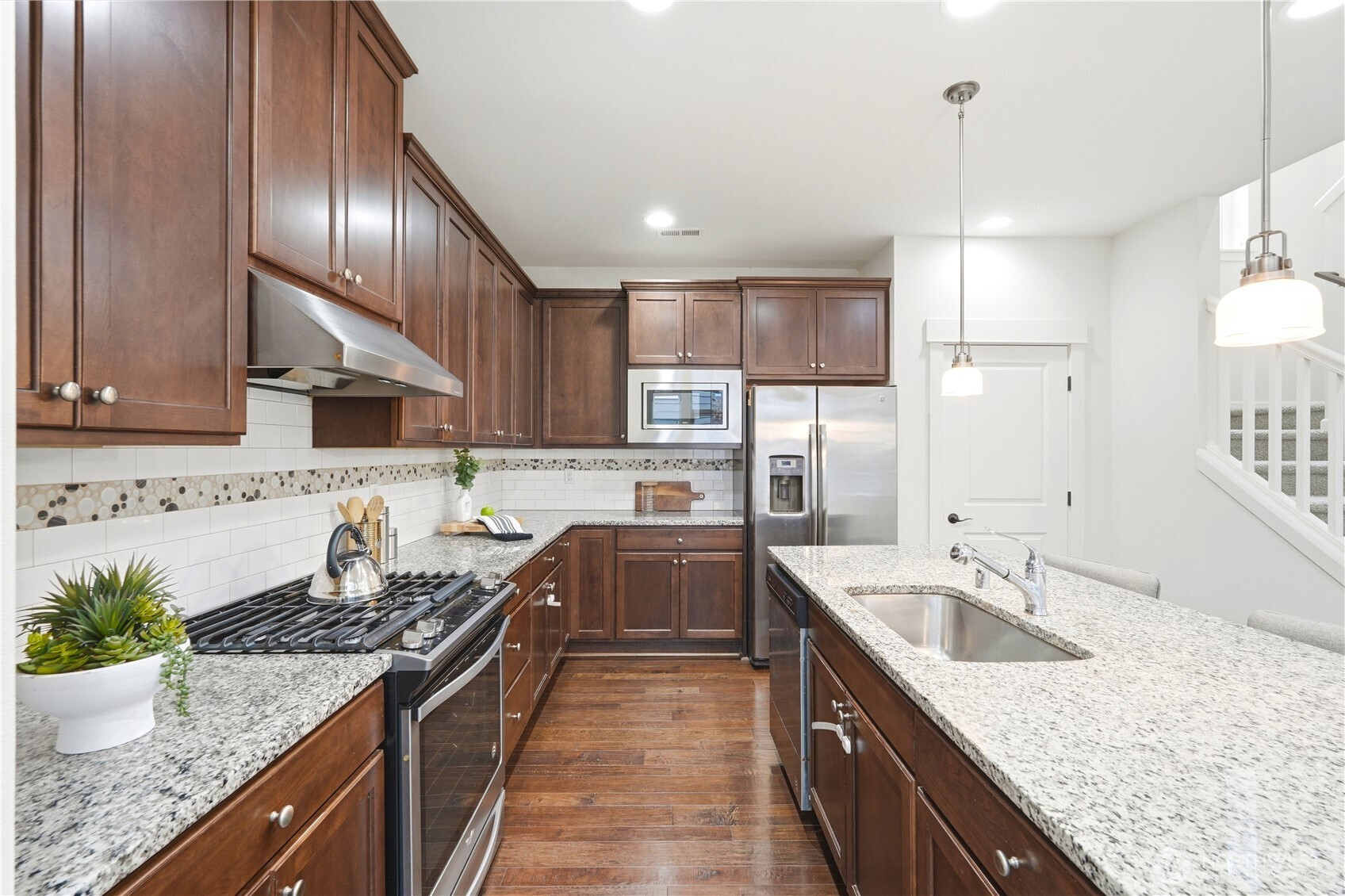 4413 185th Place Southeast Bothell, WA 98012 - Photo 15 of 40 a kitchen with stainless steel appliances granite countertop a sink stove and refrigerator