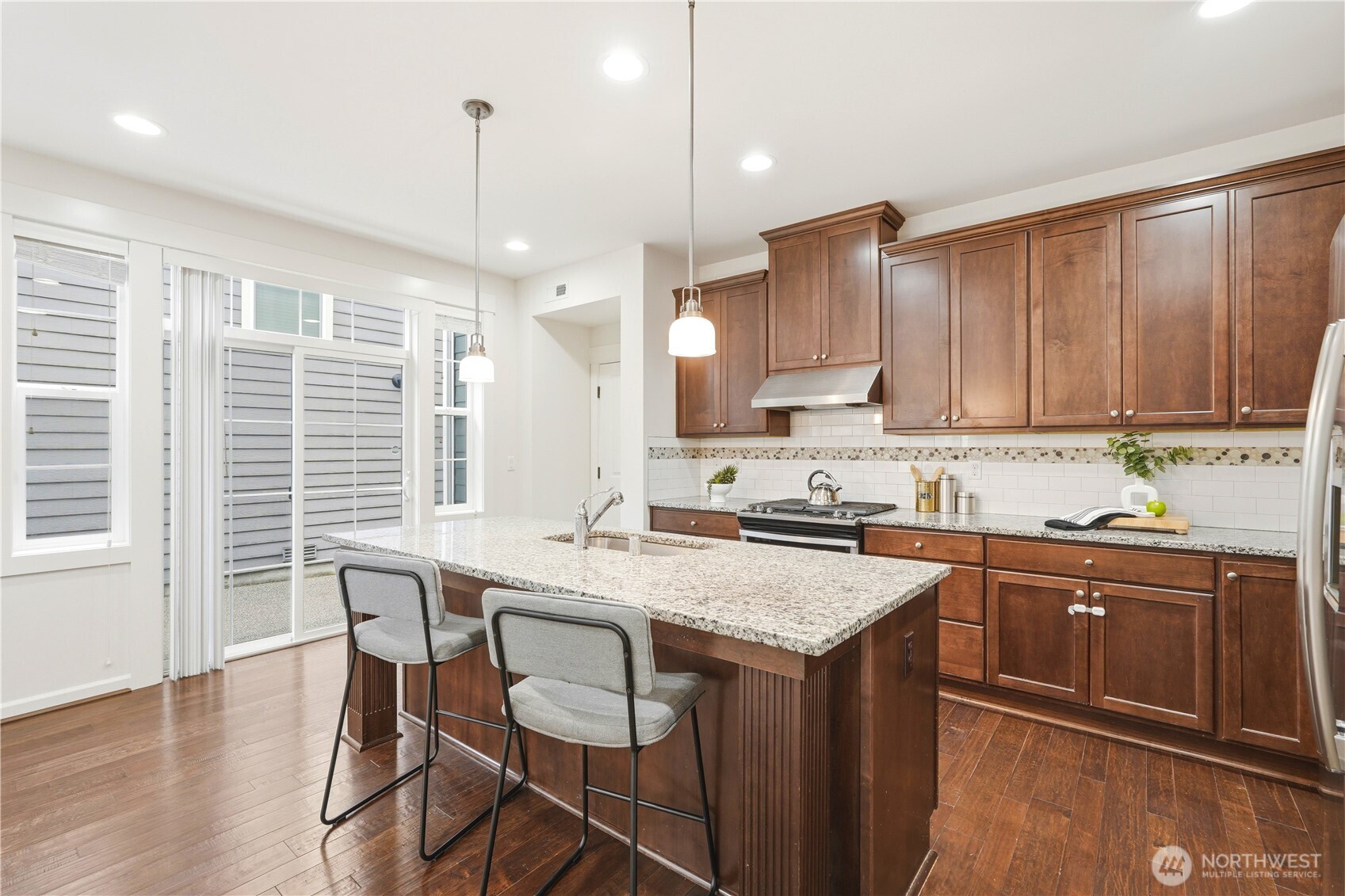 4413 185th Place Southeast Bothell, WA 98012 - Photo 16 of 40 a kitchen with a stove a sink a dining table and chairs