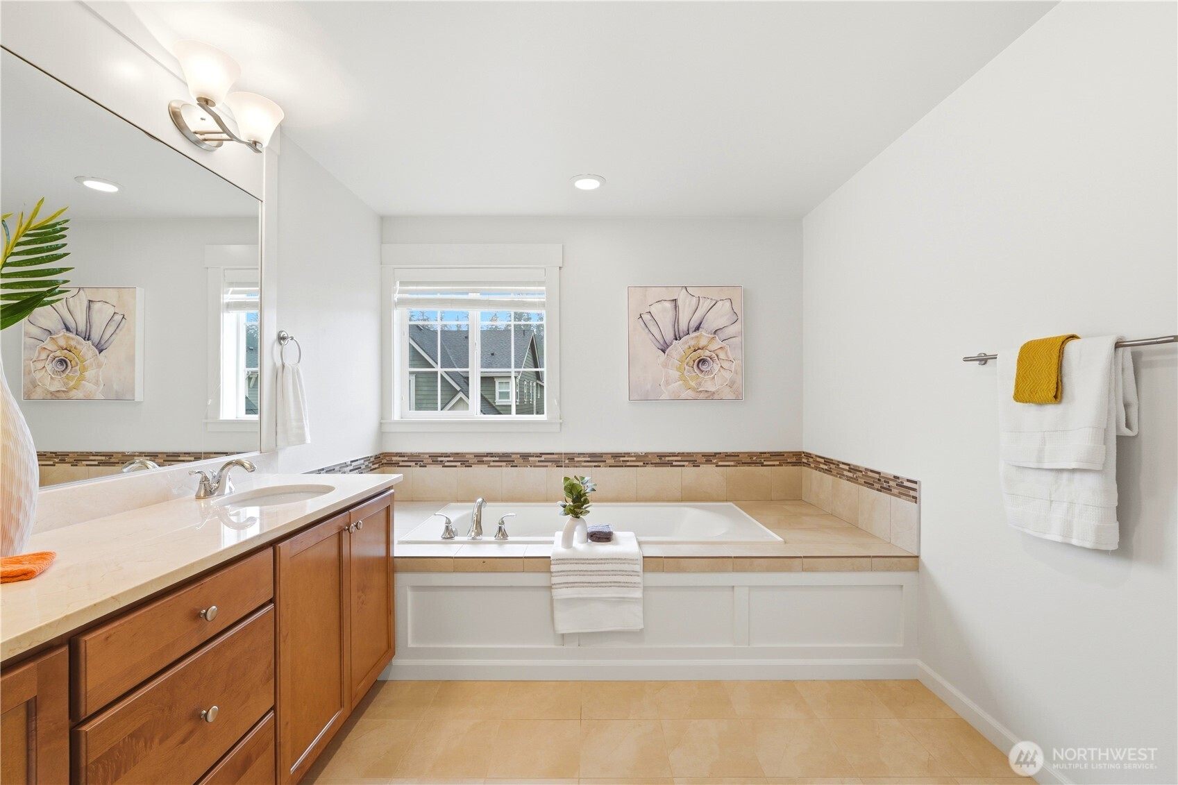 4413 185th Place Southeast Bothell, WA 98012 - Photo 22 of 40 a bathroom with a tub sink and mirror