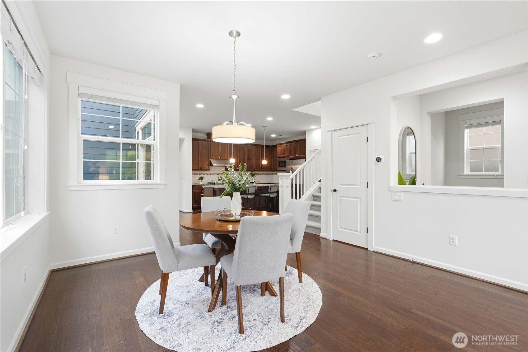 4413 185th Place Southeast Bothell, WA 98012 - Photo 10 of 40 a view of a dining room with furniture window and wooden floor