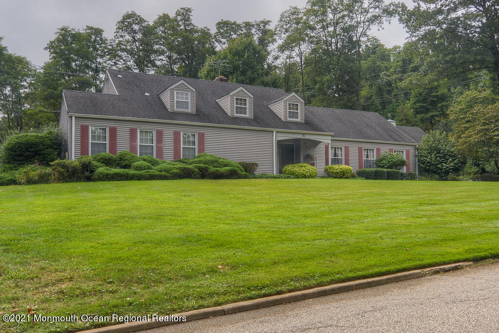 a front view of house with yard and green space