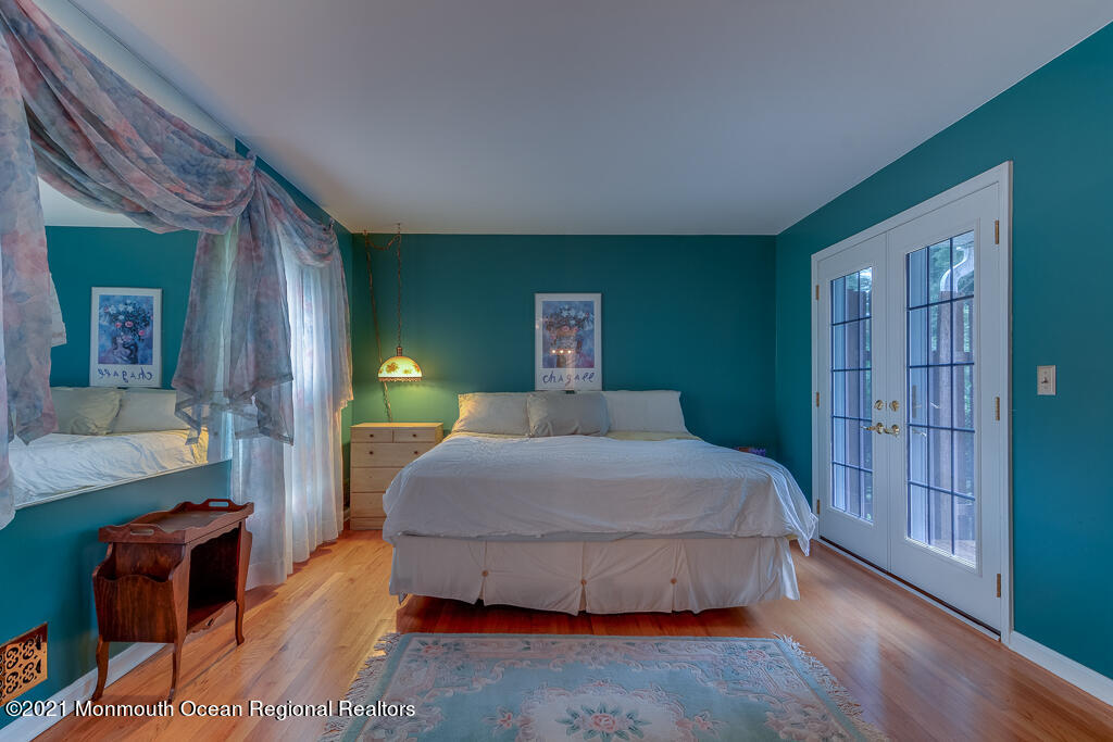 2 Flora Drive Holmdel, NJ 07733 - Photo 21 of 34 a bedroom with a large bed and wooden floor