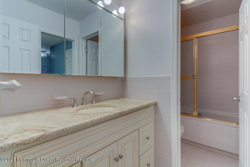 2 Flora Drive Holmdel, NJ 07733 - Photo 24 of 34 a bathroom with a sink and a mirror