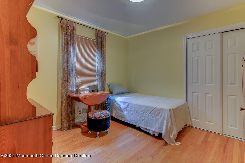 2 Flora Drive Holmdel, NJ 07733 - Photo 26 of 34 a bedroom with a bed and wooden floor
