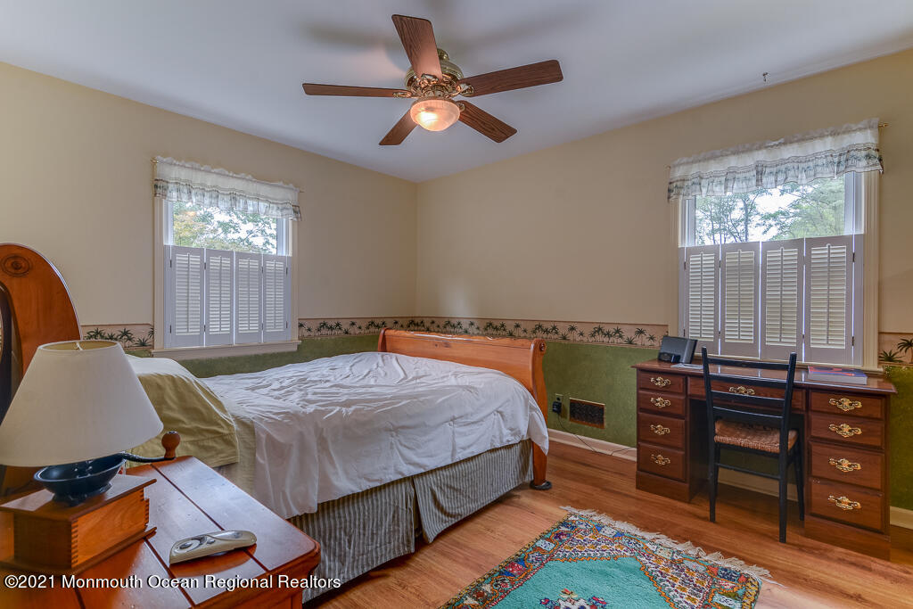 2 Flora Drive Holmdel, NJ 07733 - Photo 30 of 34 a bedroom with a bed and a table in it