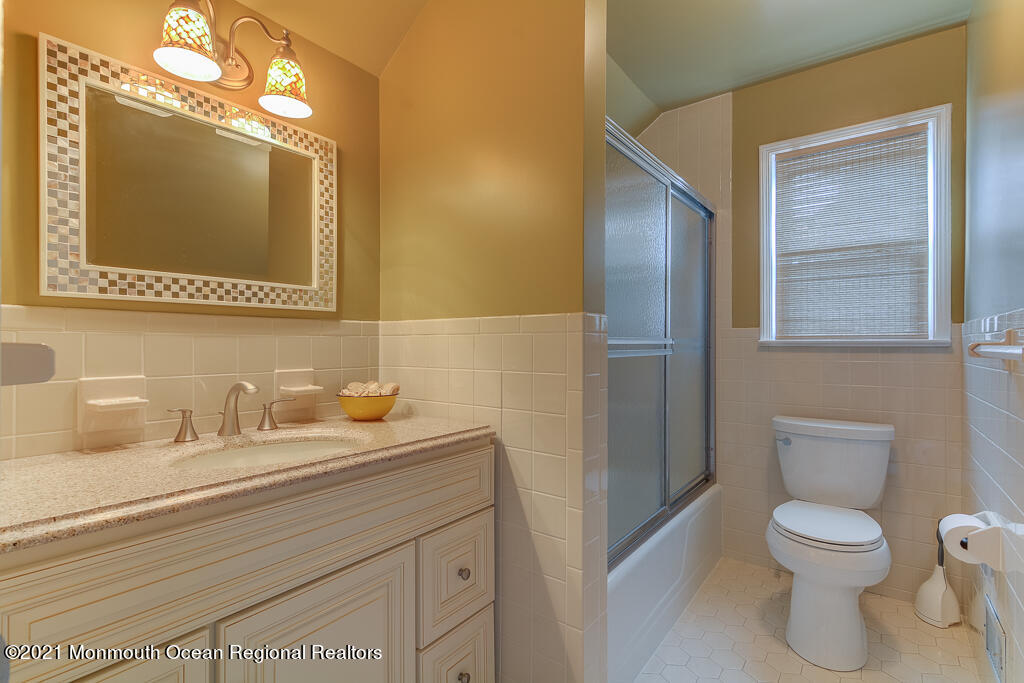2 Flora Drive Holmdel, NJ 07733 - Photo 32 of 34 a bathroom with a toilet sink and mirror
