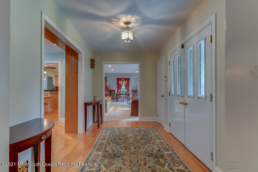 2 Flora Drive Holmdel, NJ 07733 - Photo 9 of 34 a living room with furniture and a chandelier