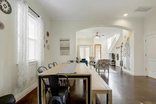 a view of a a dining room with furniture window and wooden floor