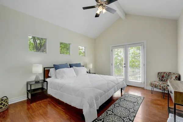 a bed sitting in a bedroom next to a window