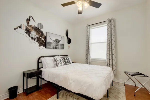 a bedroom with a bed and a chandelier