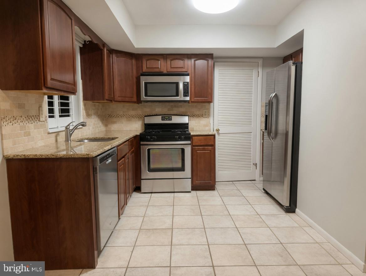 2 Goshawk Court Voorhees, NJ 08043 - Photo 11 of 33 a kitchen with stainless steel appliances granite countertop a refrigerator and a sink