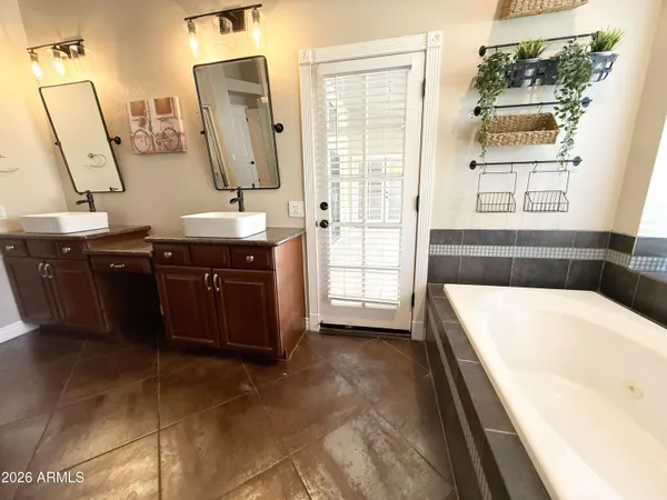 a spacious bathroom with a bathtub sink and mirror
