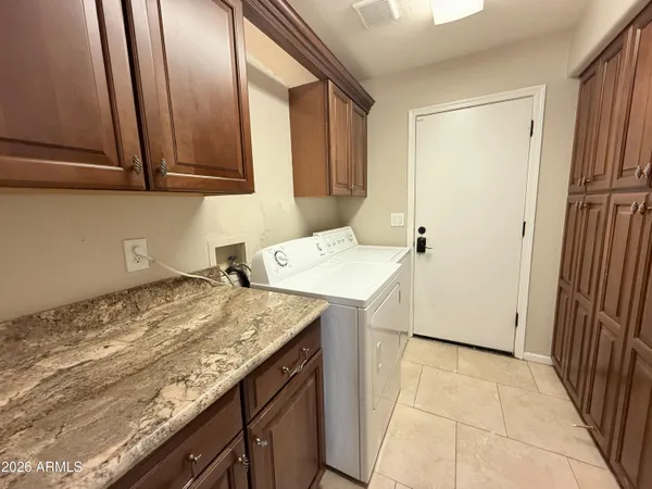 a large kitchen with kitchen island granite countertop a large counter top stainless steel appliances and cabinets