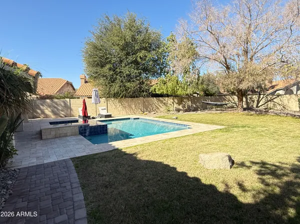 a view of a backyard with swimming pool