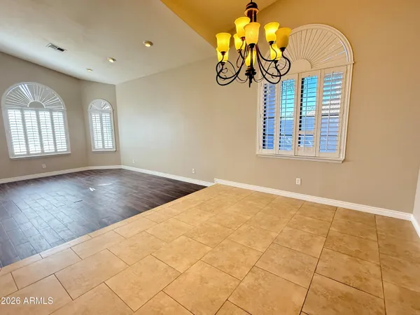 a view of empty room with window and wooden floor