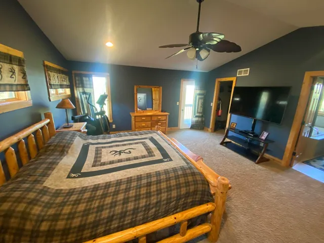 a living room with furniture a flat screen tv and a chandelier