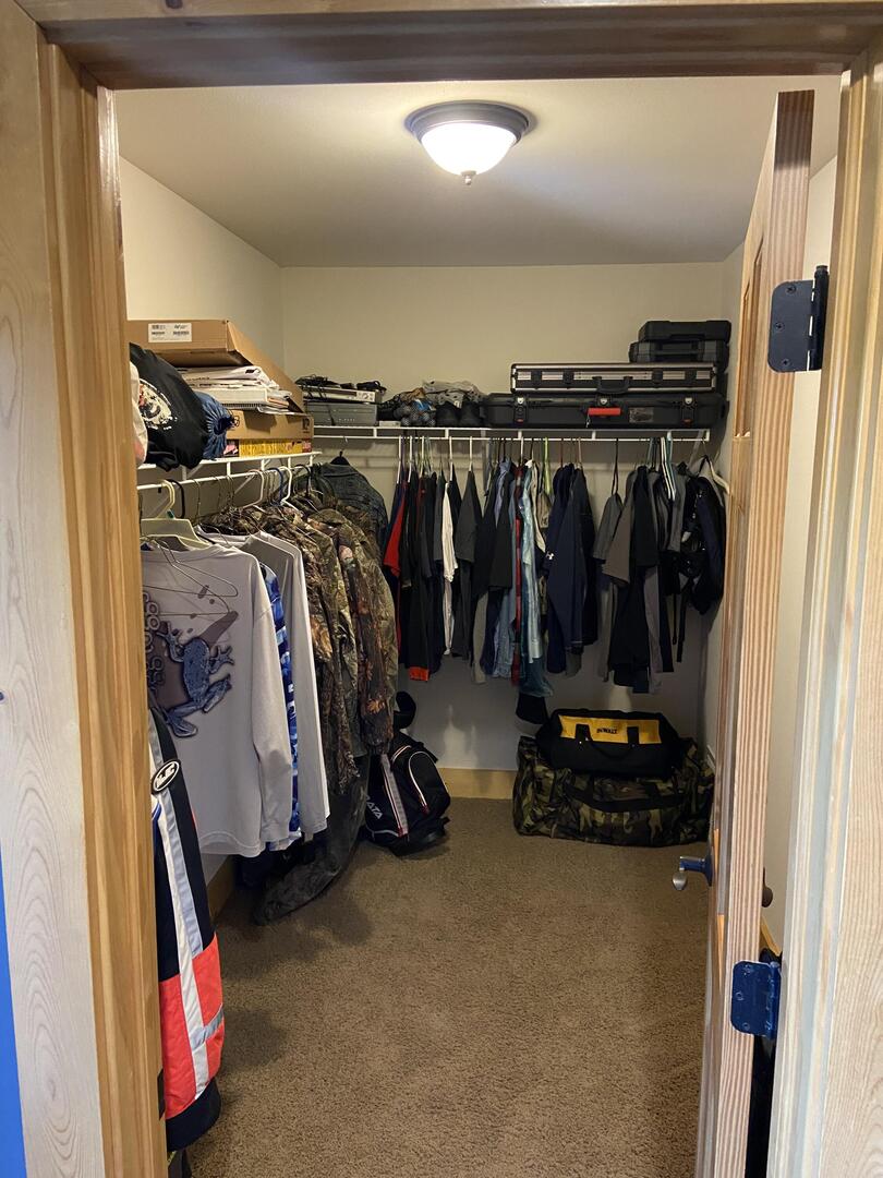 7330 North Crestview Road Stillman Valley, IL 61084 - Photo 16 of 33 a view of walk in closet with clothes and shoes