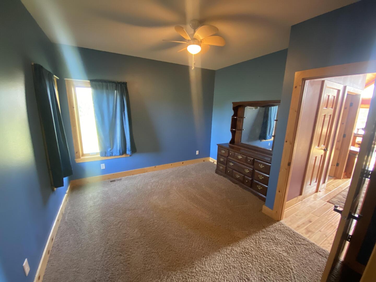 7330 North Crestview Road Stillman Valley, IL 61084 - Photo 22 of 33 a bedroom with a bed and a chandelier