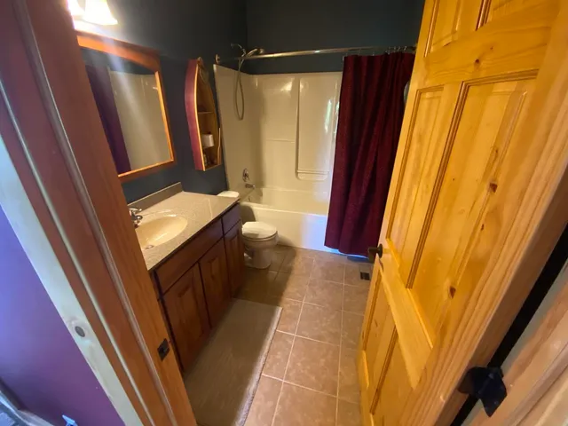 a bathroom with a sink a mirror and a shower