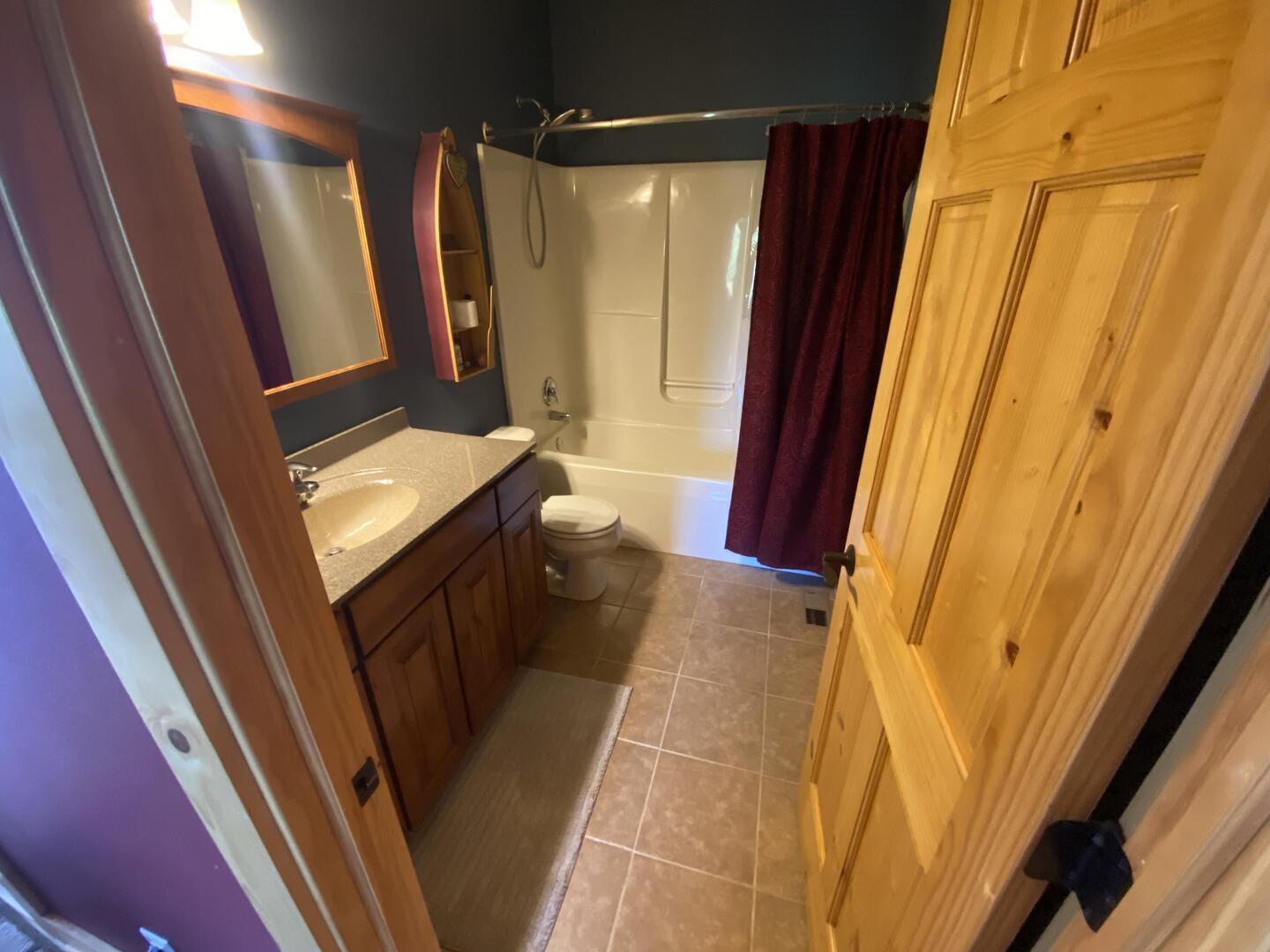 7330 North Crestview Road Stillman Valley, IL 61084 - Photo 26 of 33 a bathroom with a sink a mirror and a shower