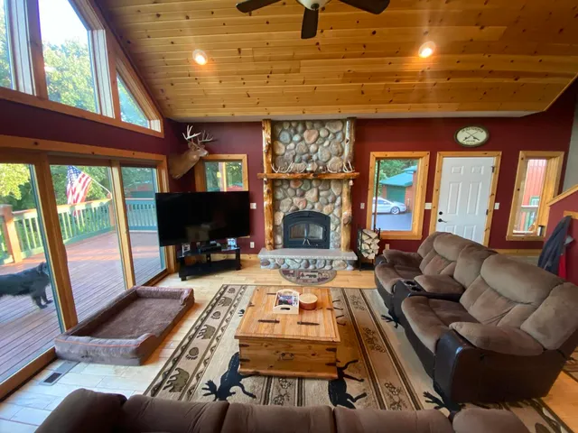 a living room with furniture a large window and a fireplace