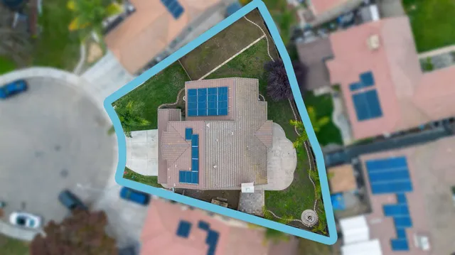 an aerial view of a house with outdoor space