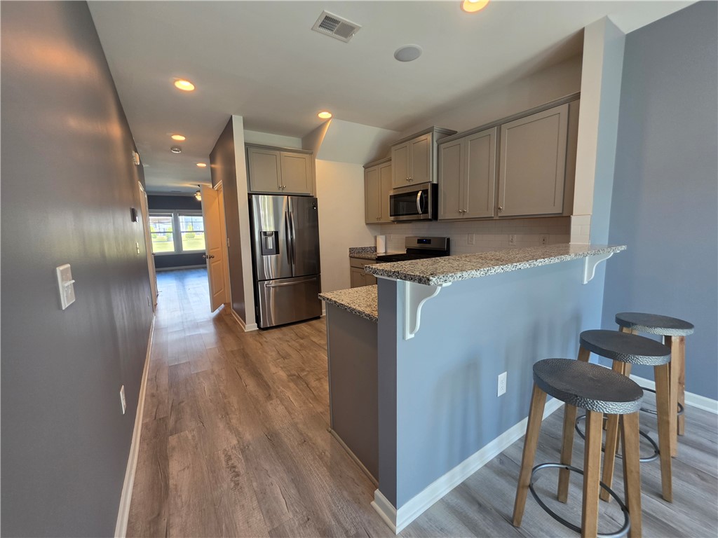 312 Phillips Drive Pendleton, SC 29670 - Photo 10 of 45 This bright kitchen features a breakfast bar, ample cabinet space, and durable flooring.