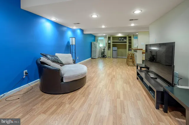 a living room with furniture a wooden floor and a large window
