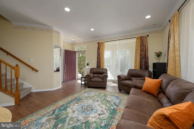 a kitchen with stainless steel appliances granite countertop a refrigerator a sink dishwasher a stove and a refrigerator with wooden floor