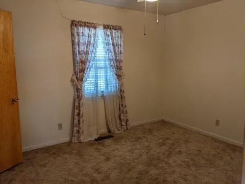 a view of a hallway with wooden floor and closet area