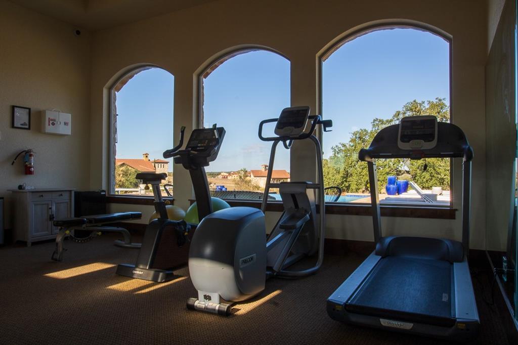 115 Strada Luca Florence, TX 76527 - Photo 19 of 25 a room with gym equipment and wooden floor