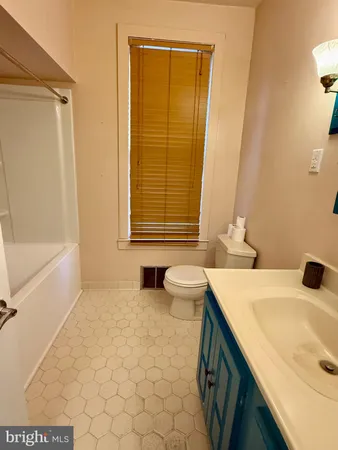 a bathroom with a sink a toilet and a bathtub
