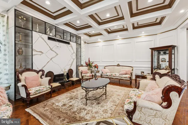 a living room with furniture a rug and a floor to ceiling window