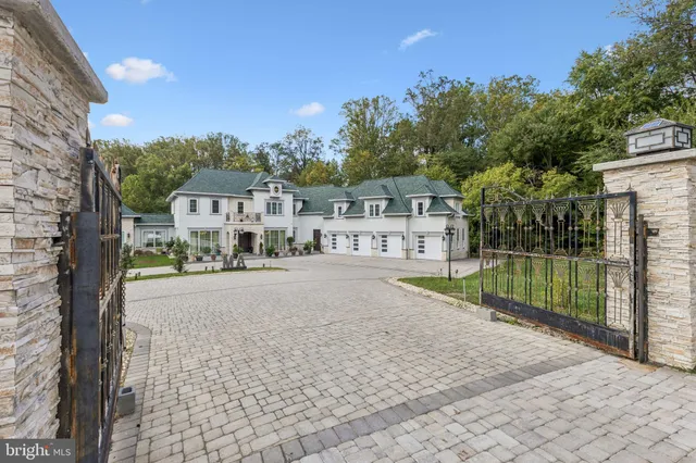 a front view of a house with a yard and potted plants