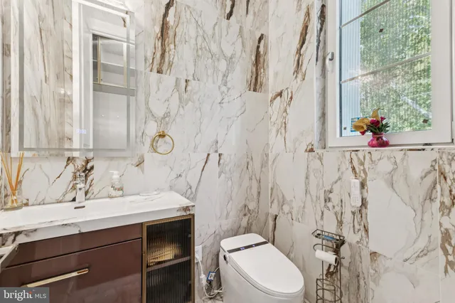 a bathroom with a sink toilet vanity and tub