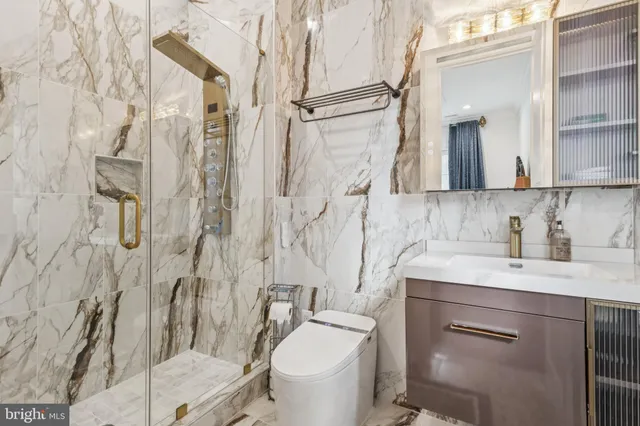 a bathroom with a sink toilet and shower