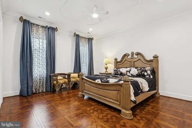 a living room with a bed furniture and a flat screen tv