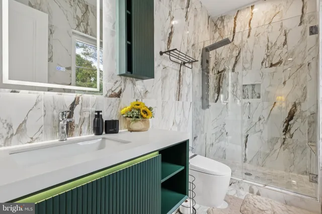 a bathroom with a sink toilet and shower