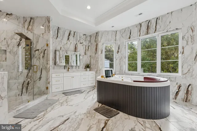 a bathroom with a tub sink and mirror
