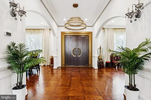 a view of a dining room with furniture and chandelier