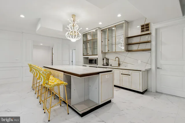 a kitchen with stainless steel appliances kitchen island granite countertop a stove a sink and a microwave