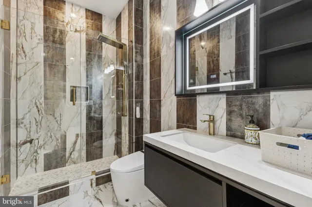 a bathroom with a sink a toilet and shower curtain