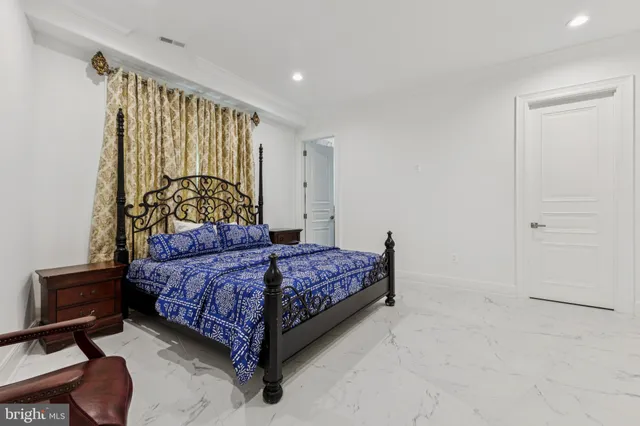 a view of a patio with table and chairs under an umbrella with a small garden